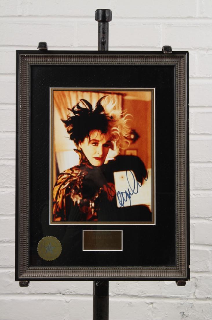 Glenn Close Signed Film Still: Glenn Close autographed film still from One Hundred and One Dalmations in wonderful gothic style frame with COA from Walt Disney World. The still is an 8x10 color glossy still with a little covered by