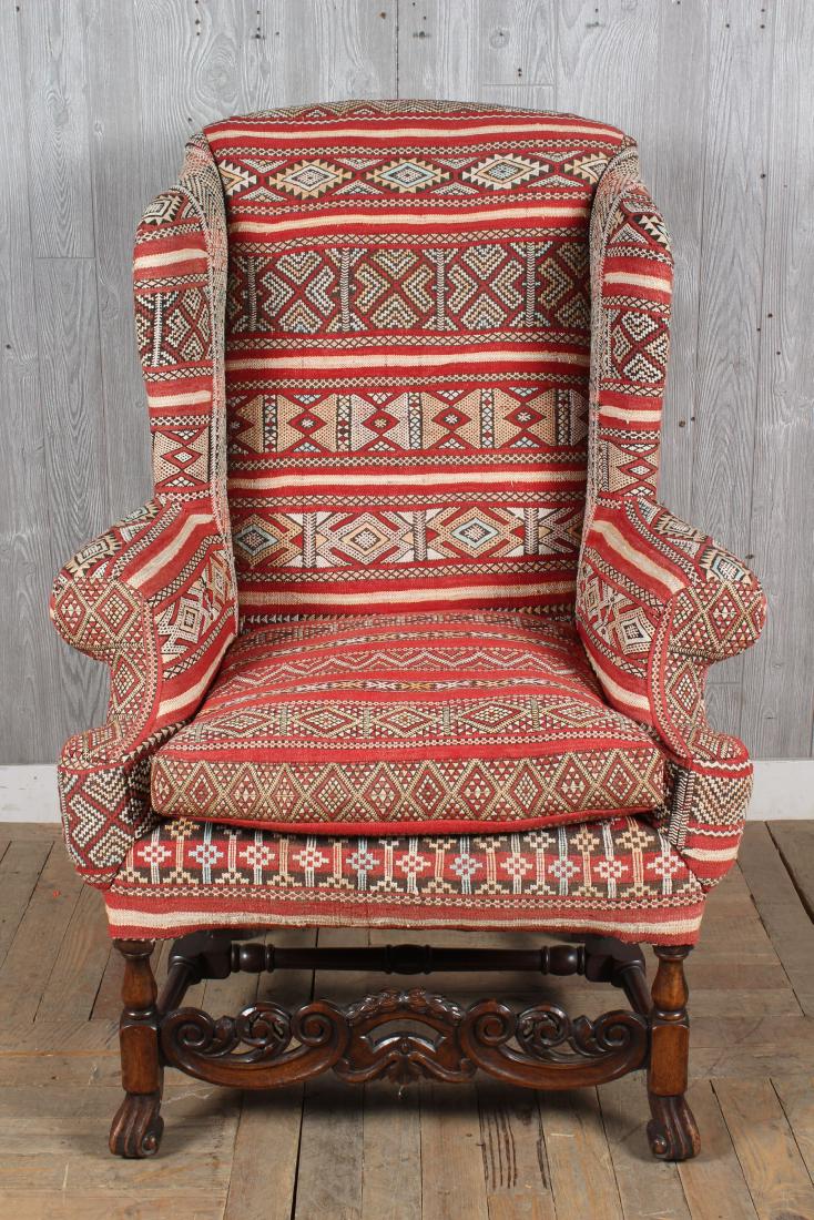 Moroccan Textile Upholsterd Wingback Chair: Moroccan Wingback Chair, carved stretcher, scroll front feet. Size: 49.5" H x 34.5" W x 26" D