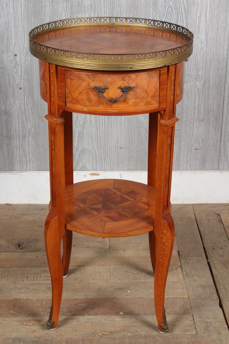 Marquetry Bronze Mounted End Table: Louis XV style marquetry inlaid side table with brass galleried top over single drawer and lower tier shelf. Size: 27.5" H x 14" W x 14" D
