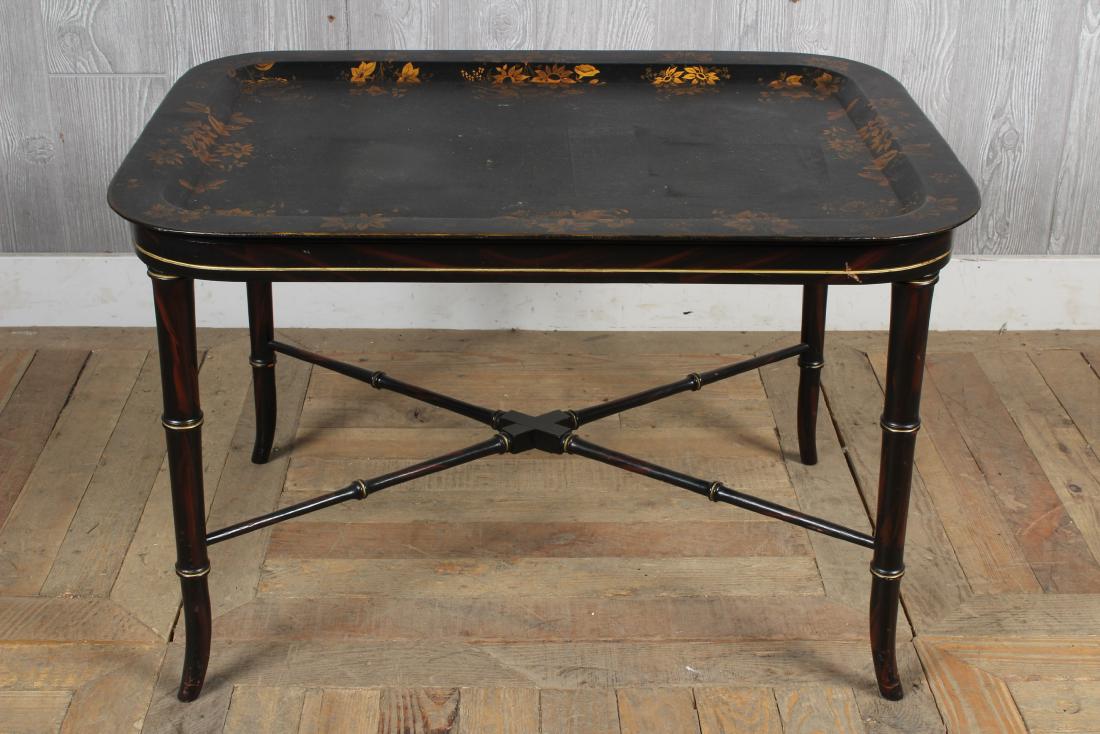 Tole Decorated Tray on Faux Bamboo Stand: A painted and gilt decorated tole tray resting on faux bamboo stand. Size: 20" H x 30" W x 23" D
