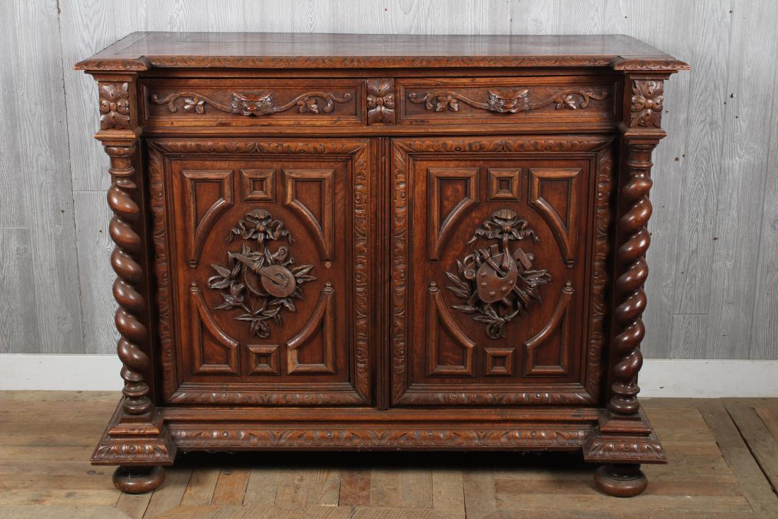 Oak Victorian Sideboard: A Victorian late 19th C. server having a gadrooned top over 2 drawers and 2 well carved doors. Size: 42" H x 53.5" W x 23" D