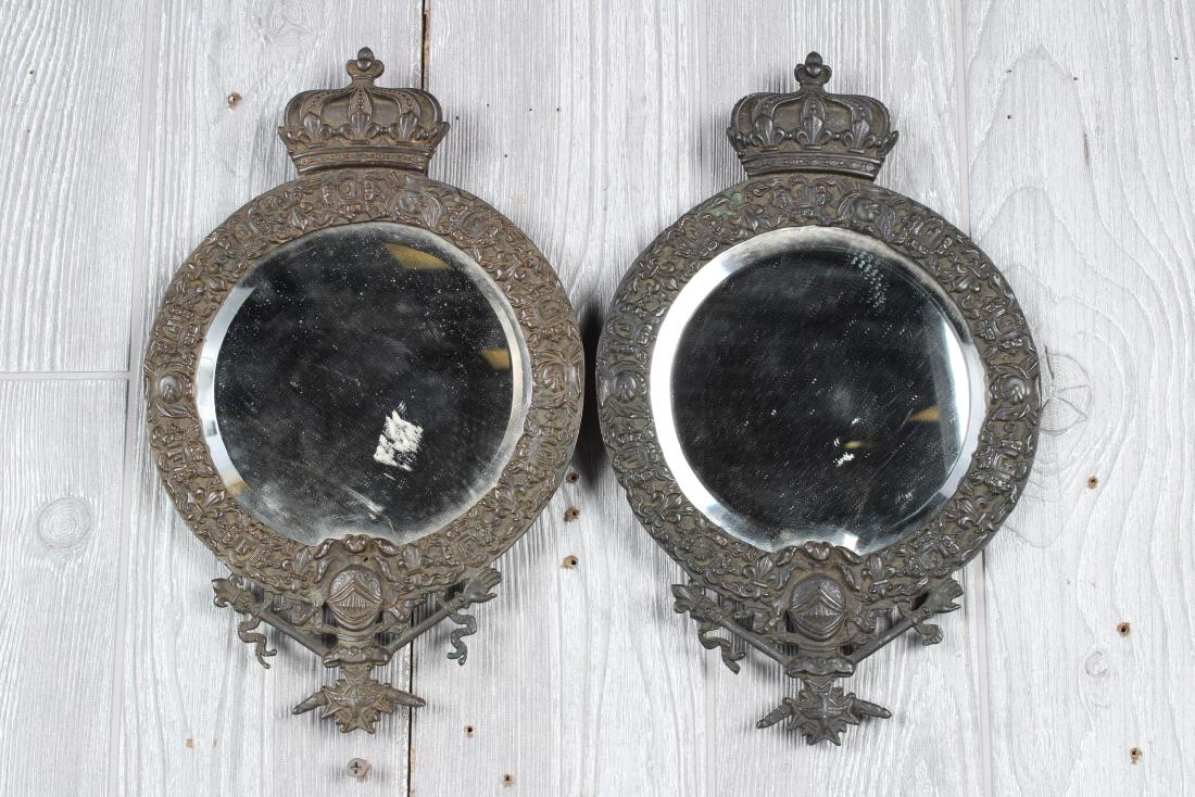 Pair French Bronze Coat of Arms Mirrors: Pair French Bronze Coat of Arms Mirrors, beveled mirrors, crown finial, depicting coat of arms at bottom of mirror, knights helmet, above cross with downward facing bird, crossed hand and Fleur de lis