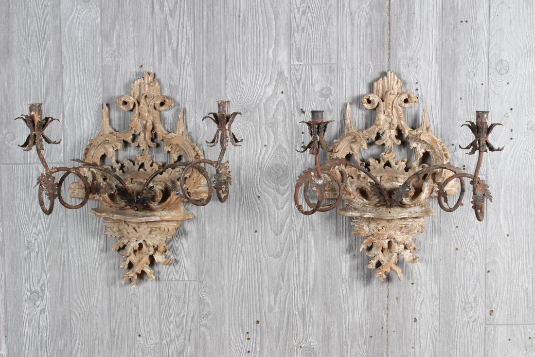 Continental Wood and Wrought Iron Sconces: Carved Wood and Wrought Iron Sconces, foliate decoration. Size: 20" H x 19" W x 15" D