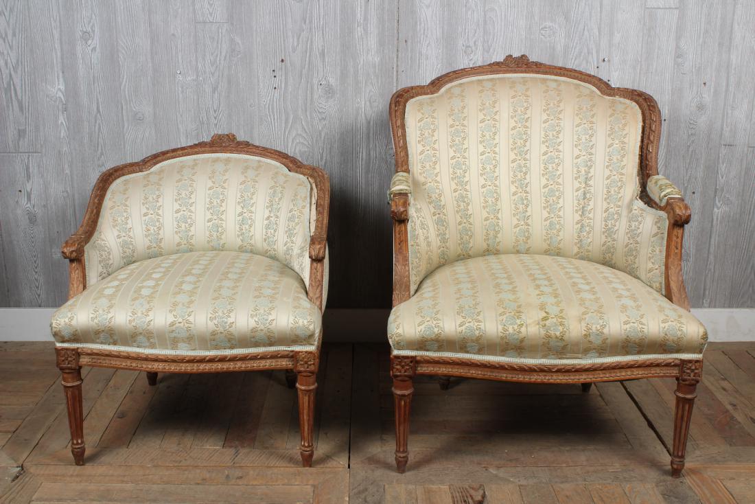 Paired French Bergeres: An interesting 2 part French Louis XVI style bergeres with carved crest rail and down swept arms. Size: Largest: 35.5" H x 27" W x 29" D