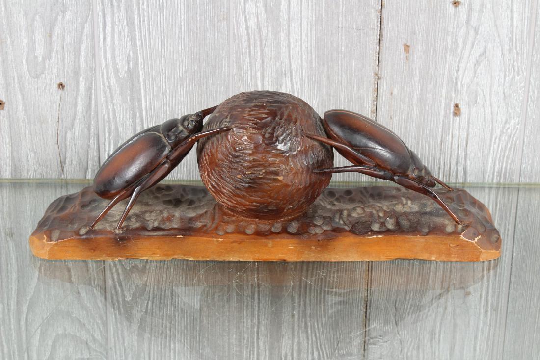 Carved Wood Dung Beetle Sculpture: A very good carved wood sculpture of 2 dung beetles rolling a ball of dung on naturalist base. Signed T Williams. Size: 5" H x 14" W x 4" D