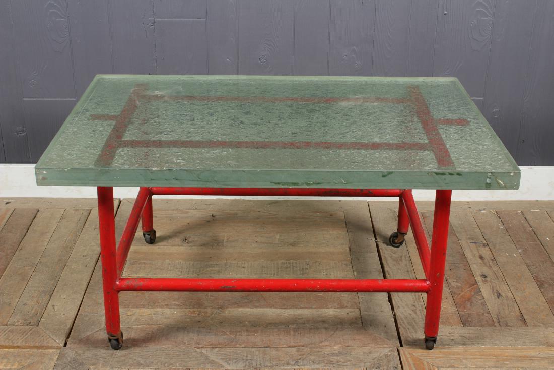 French Industrial Glass Top Coffee Table: A stylish French Modern red painted iron and thick glass top coffee table. Size: 19" H x 37" W x 24" D