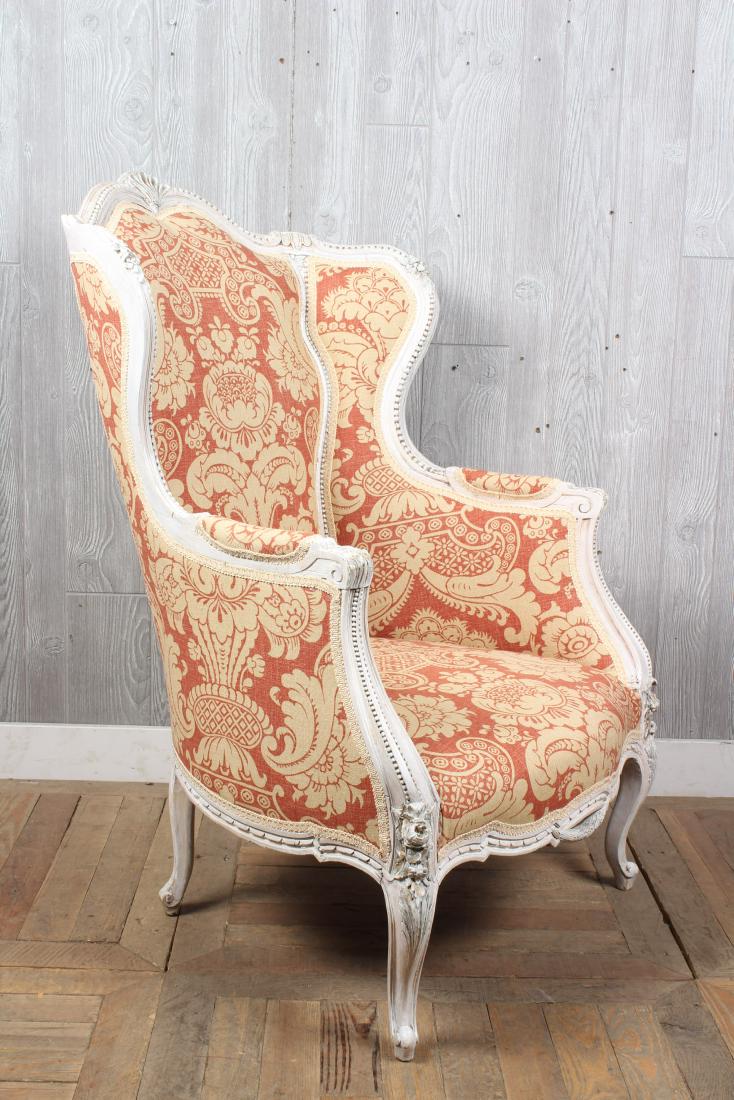 Louis XV Style Wingback Bergere: A stylish Louis XV style carved and painted winged back bergere. Size: 45" H x 31" W x 32" D