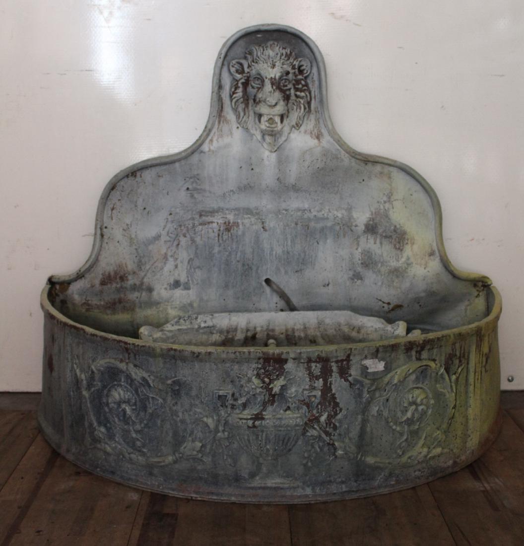 Neoclassical Lead Fountain: Neoclassical Lead Fountain. Having an arched back with central lion motif spout over a large clamshell in a demilune reservoir. Size: 41" x 26" x 47"