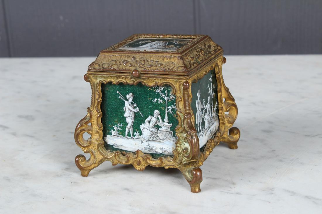 French Enamel Metal Dore Trinket Box: French Enamel Metal Dore Trinket Box, green enamel with painted courting scenes, stamped Metal Dore. Size: 2.5" H x 2.5" W x 2.5" D
