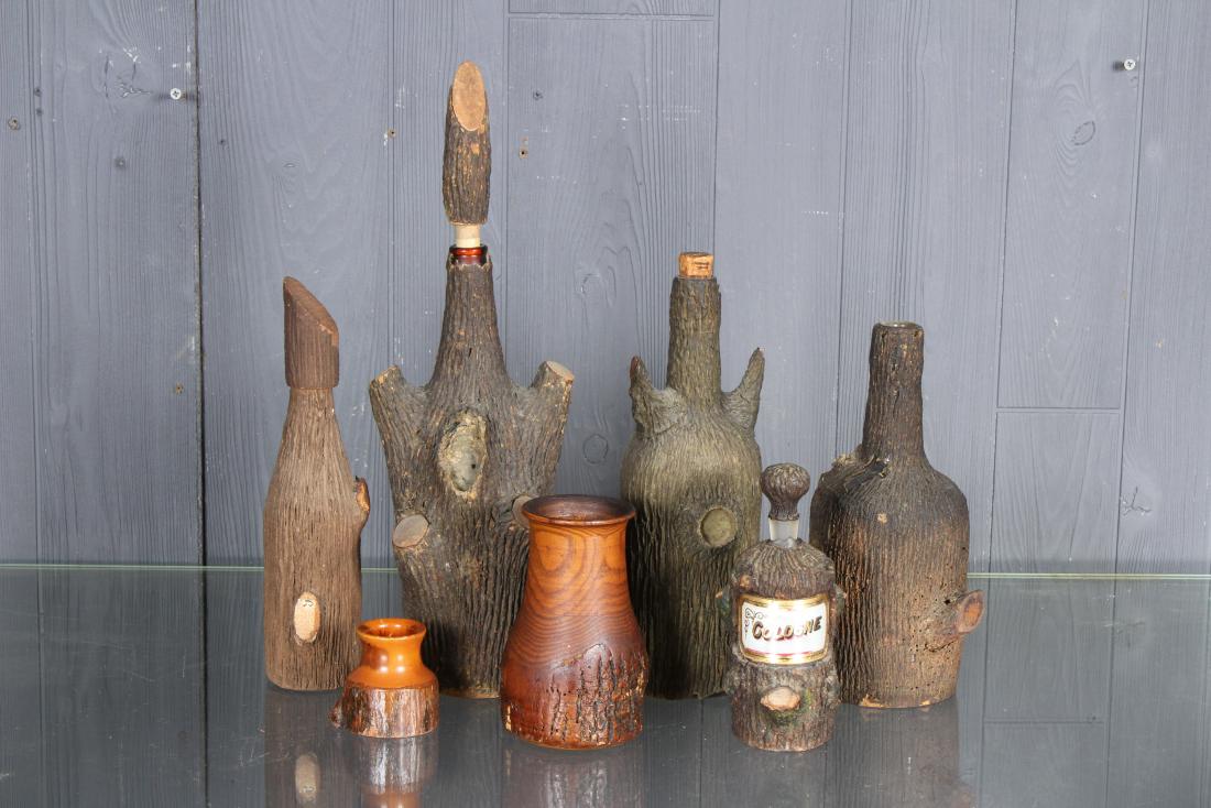 7 Piece Lot Bark Covered Bottles and Wood Vessels: 7 Piece Lot Bark Covered Bottles and Wood Vessels. 5 bark covered bottles, some with stoppers, one label Cologne on front, and two wood vessels, one marked Skowhegan, ME. Size: Largest: 17" H x 5" W x