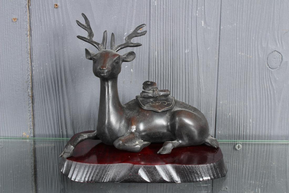 Japanese Bronze Deer Censer: Japanese Bronze Deer Censer, hinged lid with scrolls on back, signed on bottom, on a wooden base. Size: 6.5" H x 7" W x 5" D
