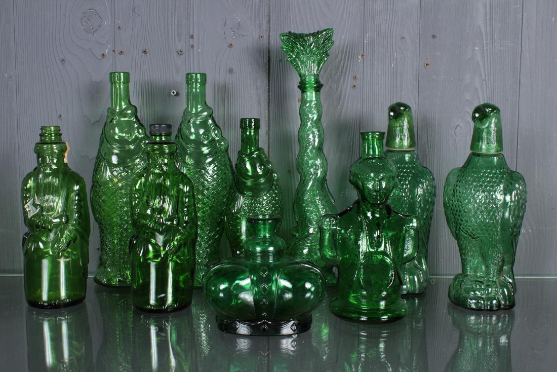 Green Figural Bottles Collection: Green Figural Bottles Collection, includes George Washington bottle, 4 fish bottles, one with fish tail stopper (ground down), 2 Moses bottles, 2 eagle decanters, and a green crown bottle marked Victo