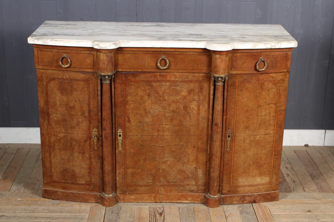 French Empire Style Sideboard: A late 19th to turn of the century French Empire style server, having a shaped marbled top, burled and banded doors framed by bronze mounted columns. Size: 34.5" H x 51" W x 20" D
