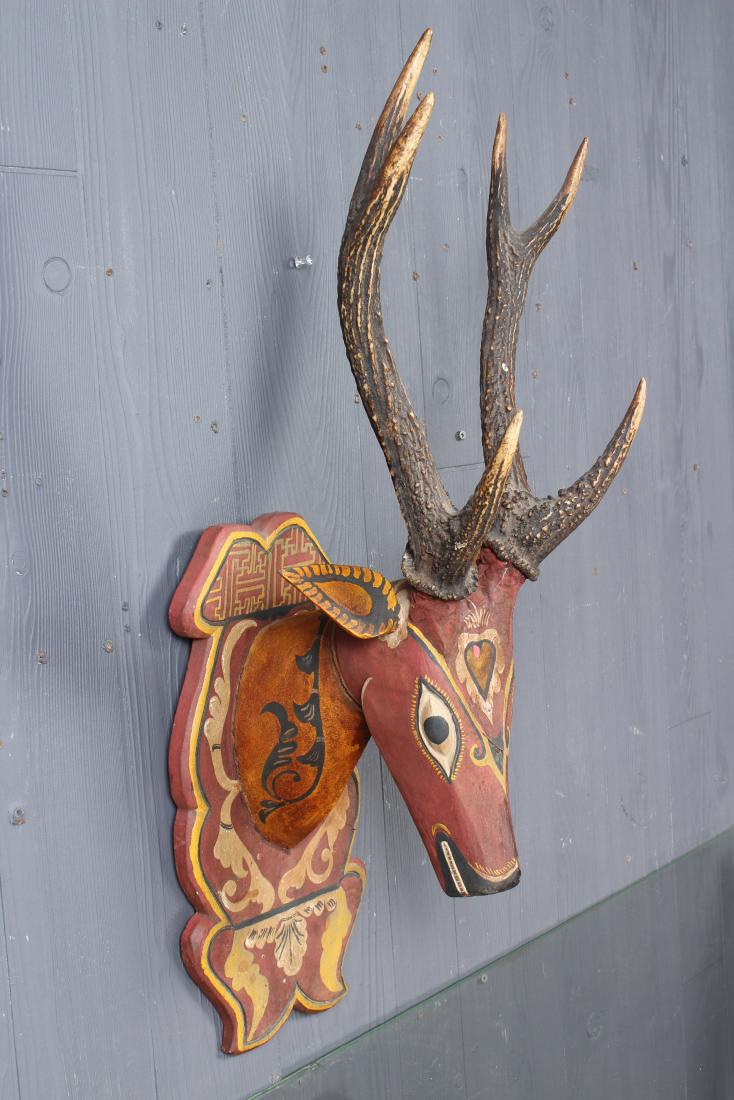 Balinese Polychrome Wood Carved Deer Mount: Balinese Polychrome Wood Carved Deer Mount with horns. Decorated in red, yellow, black and white, with antlers. Size: 28" H x 11" W x 12" D