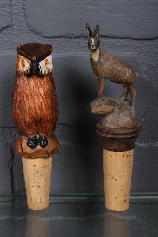 2 Carved Wood Owl and Ram Bottle Stoppers: 2 Carved Wood Owl and Ram Bottle Stoppers, perched owl, marked Italy, and a ram standing on a rock, stamped 9881 on bottom. Size: Largest: 5.25" H x 1.5" W x 1.25" D.