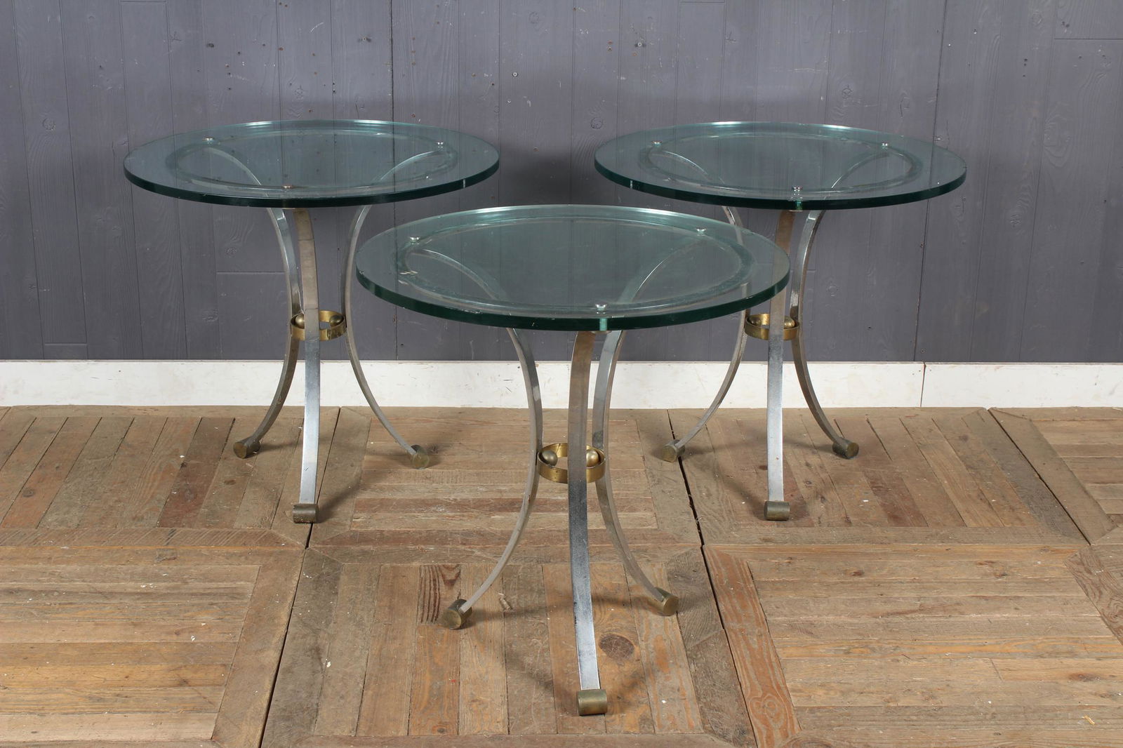 3 Maison Jansen Style Gueridons: 3 Maison Jansen Gueridons. Chrome and brass legs, round glass tops. Size: 27.5" H x 29" W x 29" D