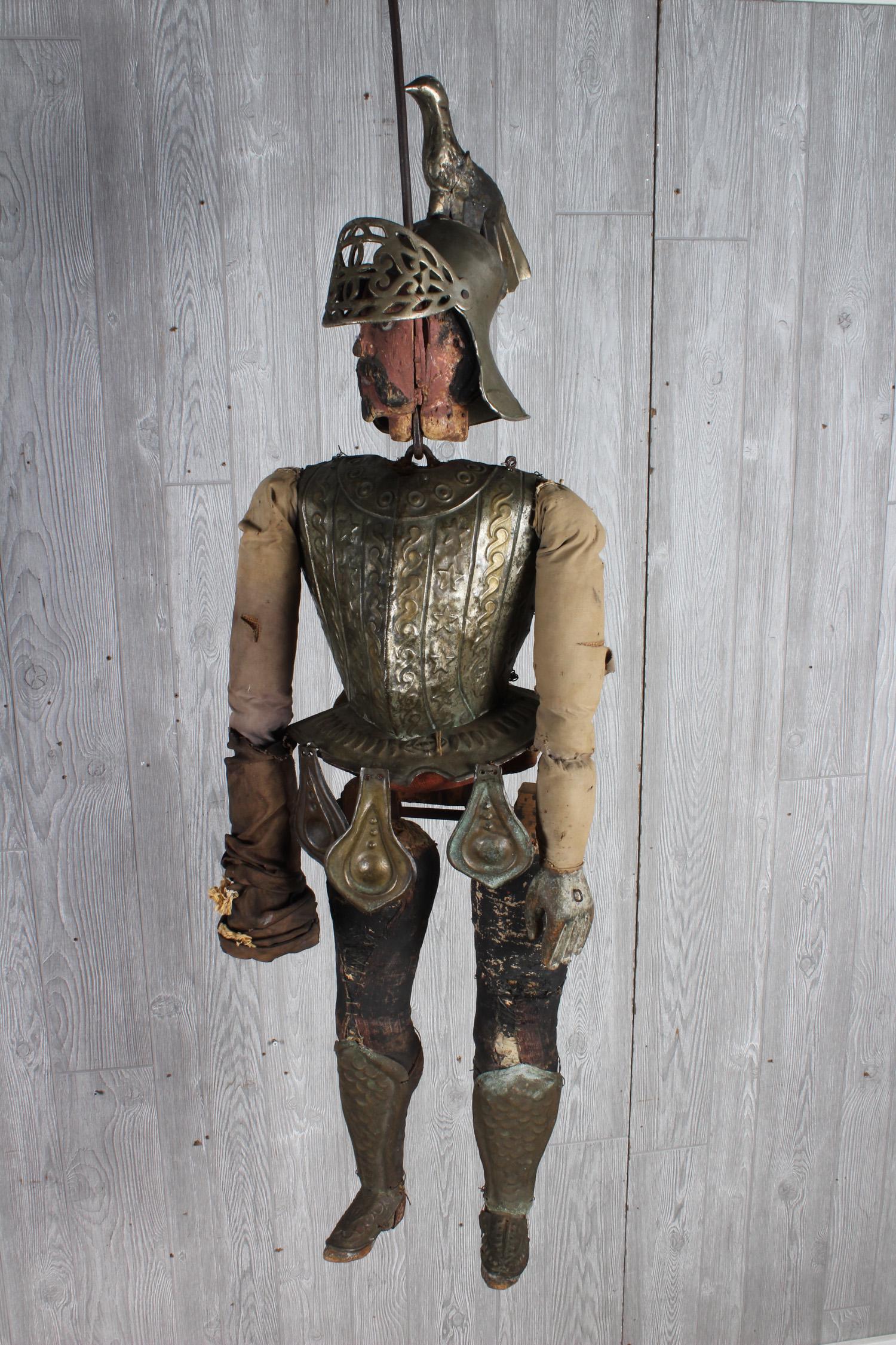 Antique Sicilian Rod Puppet: A good antique 19th century carved and painted puppet dressed in tin well detailed armor with bird decorated helmet. Body is burlap, canvas and cloth. Size: 58" H x 17" W x 12" D