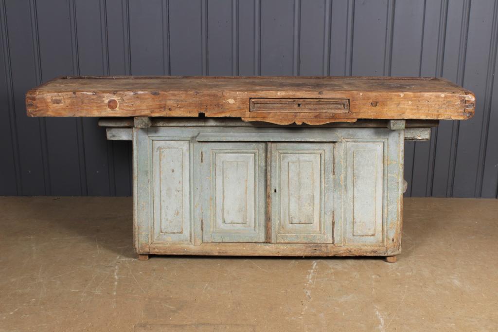 Unique Antique Continental Carpenters Bench: Unique Antique Continental Carpenters Bench. Heavy timber work surface over a raised panel tool storage cabinet. Easily converted to a kitchen island or foyer table. Size: 33.5" H x 80.5" W x 21.5" D