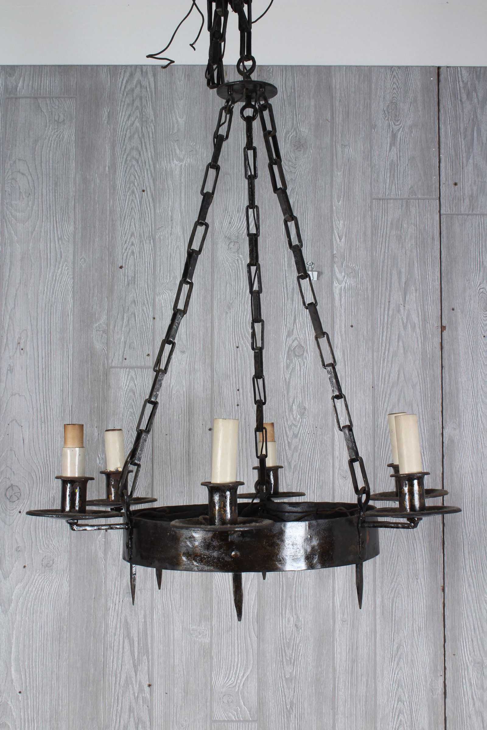 Gothic Style Wrought Iron Chandelier: An early 20th century Gothic style wrought Iron hanging chandelier. Size: 34" H x 28.5" W x 28.5" D. Due to the nature of the size and scale of these items, preview is strongly recommended. Please not