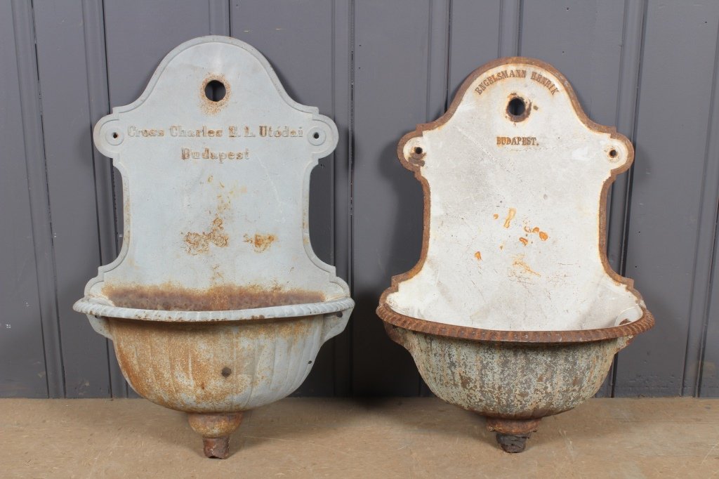 2 Cast Iron Lavabos: 2 Cast Iron Lavabos. One marked Cross Charles E. L. Utodai Budapest, 31" H x 20.5" W x 10.5" D. One marked Engelsmann Henrik Budapest, 29.5" H x 20.5" W x 10.5" D.