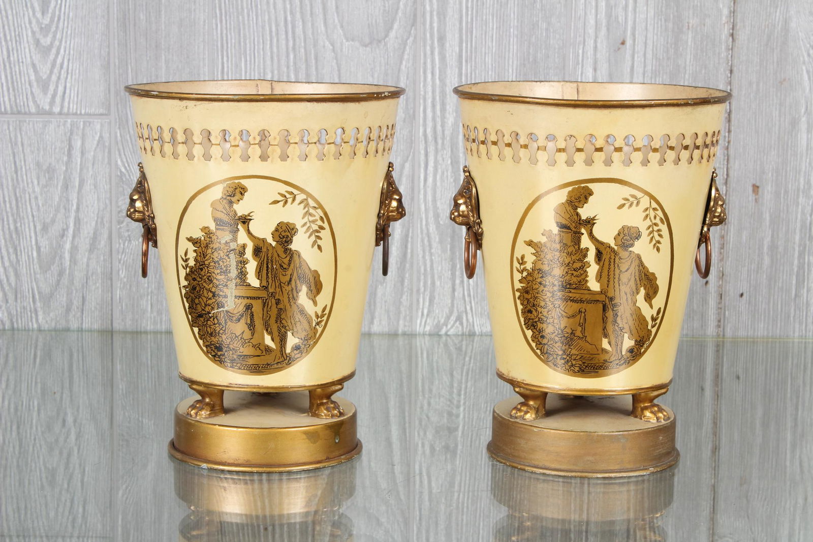 Pair French Tole Painted Cachpots: A pair of French tole decorated planters with lion form handles and paw feet. Size: 9" H x 6.5" W x 6.5" D