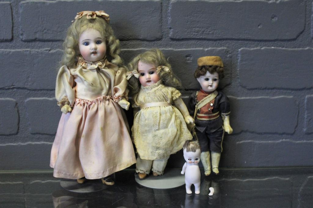 Four Small Bisque Dolls: Four Small Bisque Dolls, includes Recknagel bisque socket head doll, composition jointed body, blue glass stationary eyes, painted lashes, open mouth with upper teeth, incised on head "R/A DEP I 11/0"