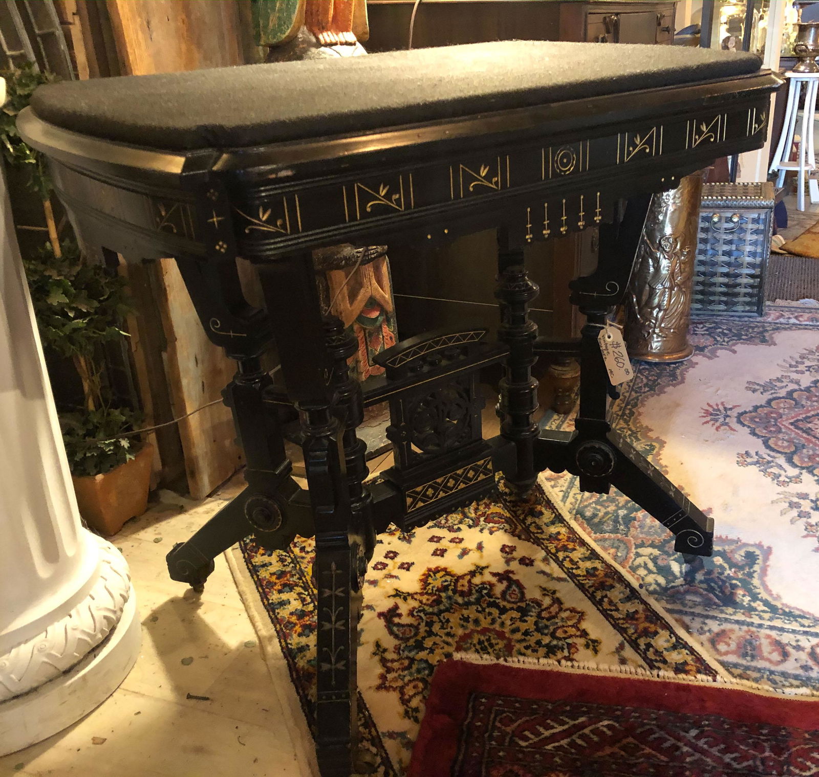 American 19th C. Victorian Ebony and Gilt Table: American 19th C. Victorian Ebony and Gilt Incised decoration center table with felt top and ornate stretcher. Size: 31" x 34" x 24"