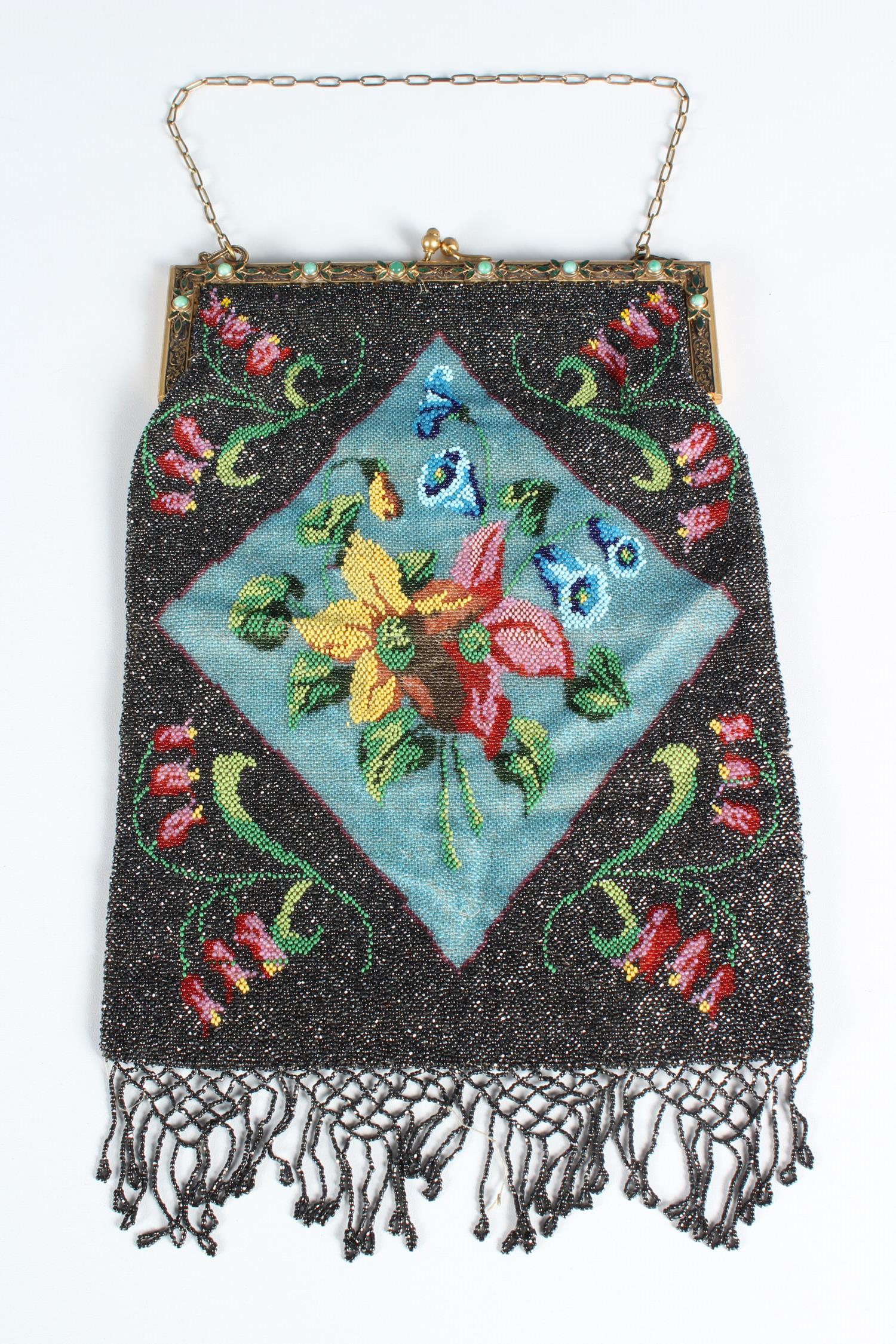 Vintage Beaded Evening Bag: Vintage Beaded Evening Bag, polychrome floral motif, beaded fringe, gold plated frame with green colored stones and green enameled foliate decoration, satin lined with two interior pockets. Size: 13.5