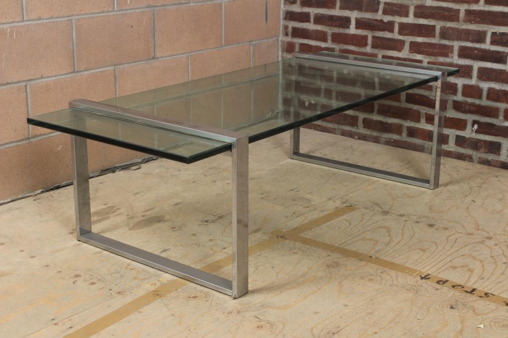 Modern Chrome and Glass Coffee Table: Modern Chrome and Glass Coffee Table. Size: 17.5" H x 60" W x 25.5" D