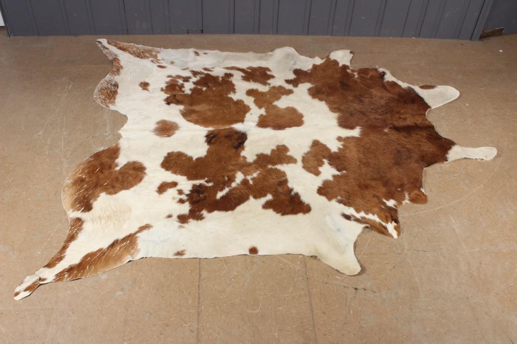 Cowhide Rug: Cowhide Rug. Size: 94" L x 85" W