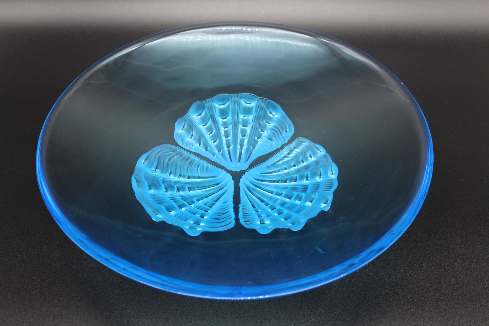 Lalique Rockley Blue Glass Round Bowl: Lalique Rockley Blue Glass Round Bowl, three frosted glass shell form feet, signed Lalique France on shell. Size: 3.25" H x 14" Diameter.