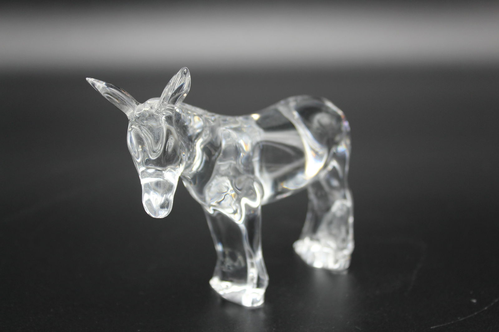 Baccarat Signed Crystal Donkey Figurine: Baccarat Signed Crystal Donkey Figurine, script signature on back, acid stamped Baccarat France on bottom. Size: 4" H x 5" W x 1.5" D.