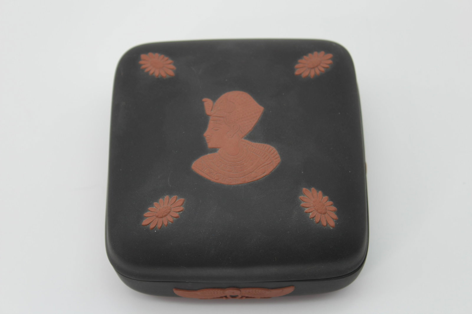 Wedgwood Black Basalt Egyptian Motif Covered Box: Wedgwood Black Basalt Egyptian Motif Covered Box, with Pharoh's bust, wings, and flowers. Wedgwood England on bottom. Size: 1.75" H x 4" W x 4" D.