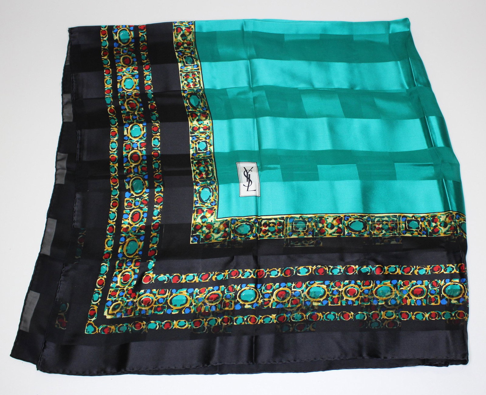 Yves Saint Laurent Silk Scarf: Yves Saint Laurent Silk Scarf or Shawl, black border with turquoise and gem design, labeled, Made in Italy. Size: 53" H x 53" W.