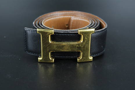 Hermes Black & Brown Reversible Leather Belt: Hermes Black & Brown Reversible Leather Belt, Constance H buckle, marked Hermes on buckle, stamped Hermes Paris Made in France on belt, impressed 100. Size: 44.5" L x 1.5" W.