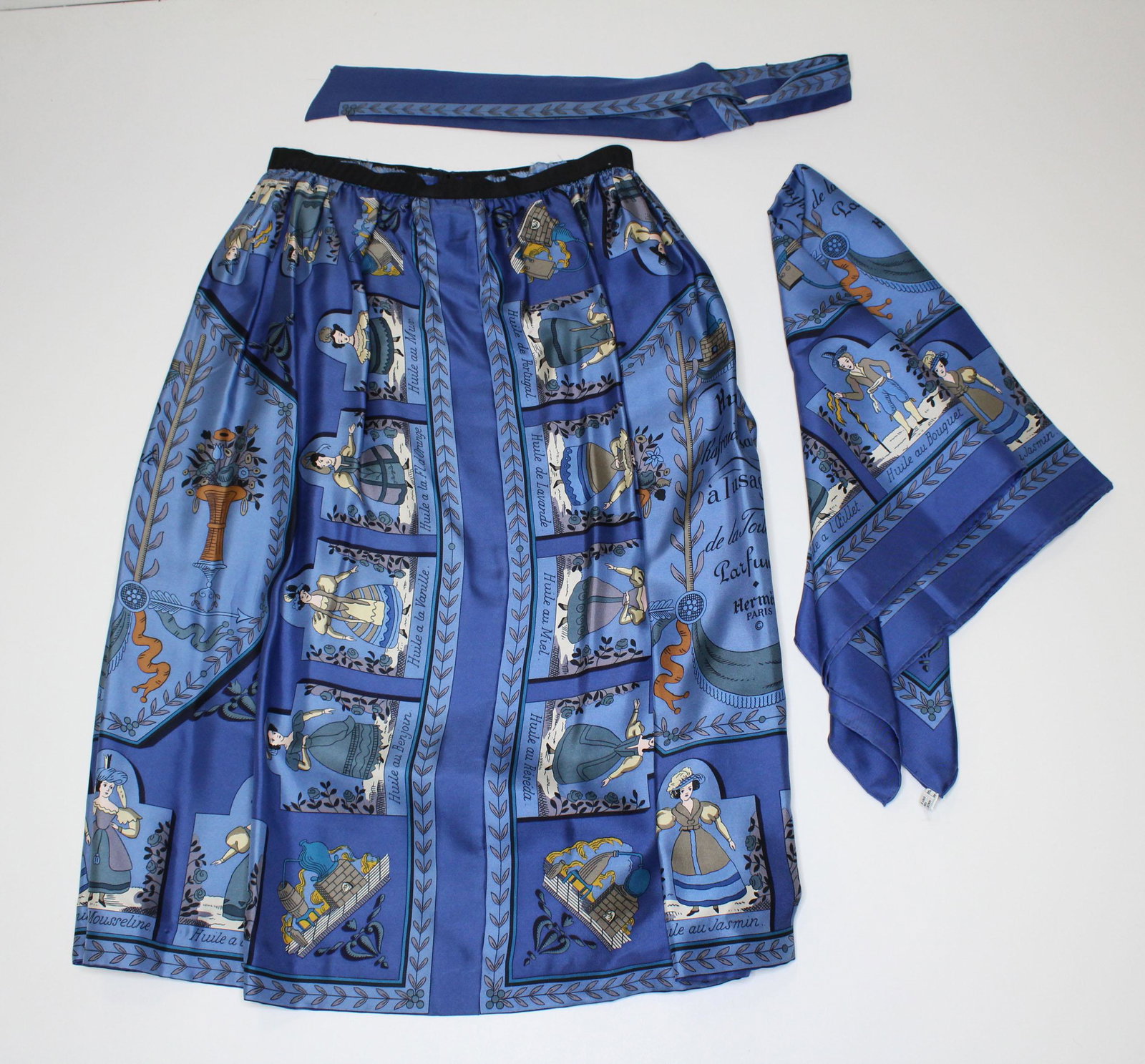 Hermes Huile Rafraichissante Silk Scarf and Skirt: Hermes Huile Rafraichissante Silk Scarf and Skirt, Huile Rafraichissante a lusage de la Toilette Parfumee, blue ground, measures 35" x 35", and a matching silk skirt, waist has been altered to an elas