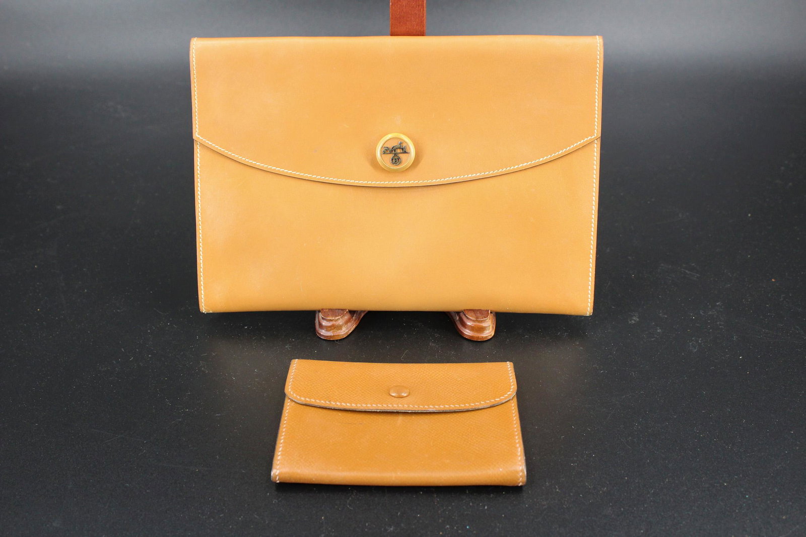 Hermes Brown Leather Rio Clutch: Hermes Brown Leather Rio Clutch, horse carriage motif snap closure, marked Hermes Paris, Made in France, with an additional brown leather change wallet (not marked) and a cloth bag with Hermes horse a