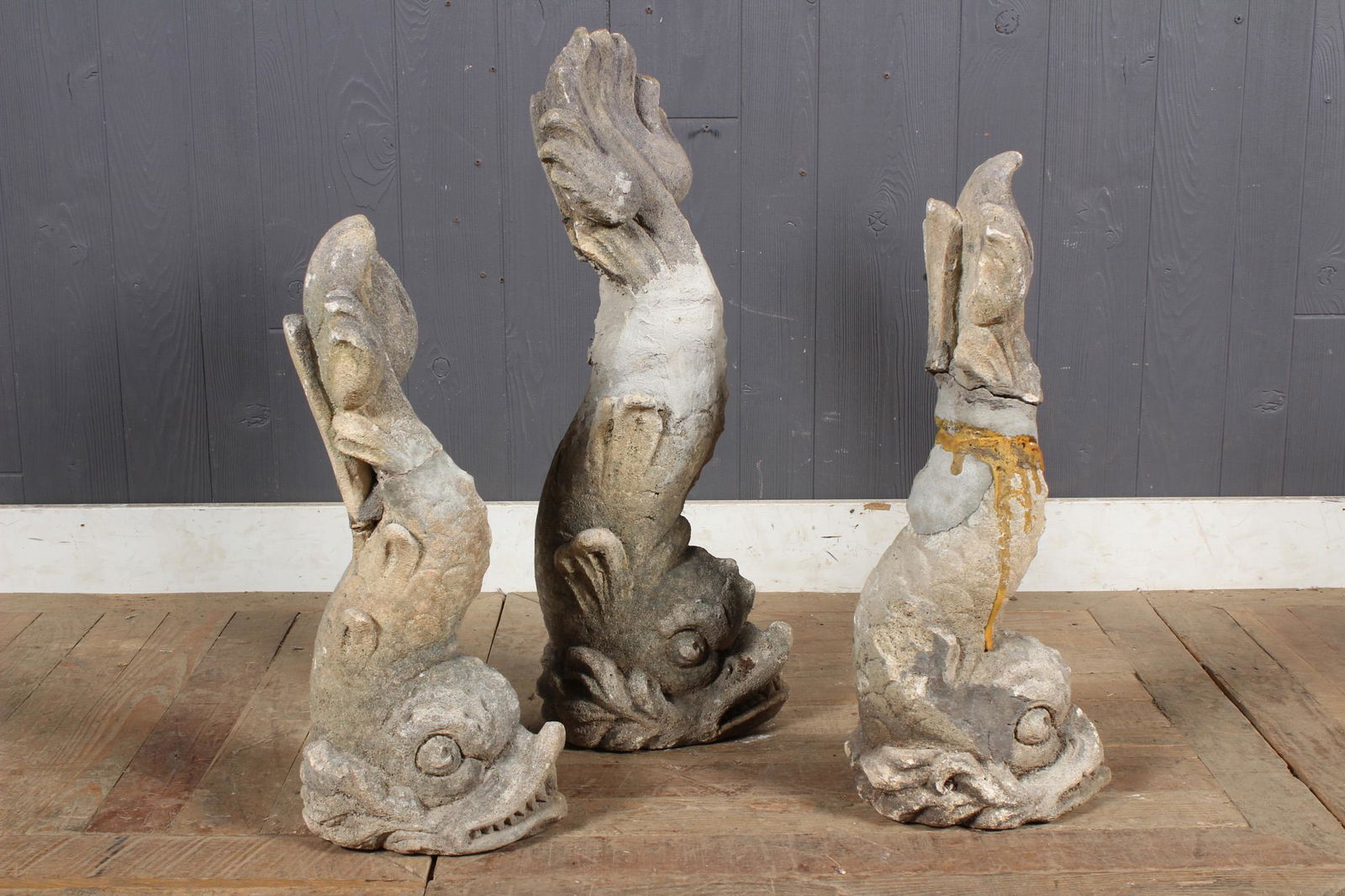 3 Limestone Dolphins: A group of three cast stone mythological dolphin fountain figures. Early 20th century. Size: Largest: 26" H x 7" W x 9" D
