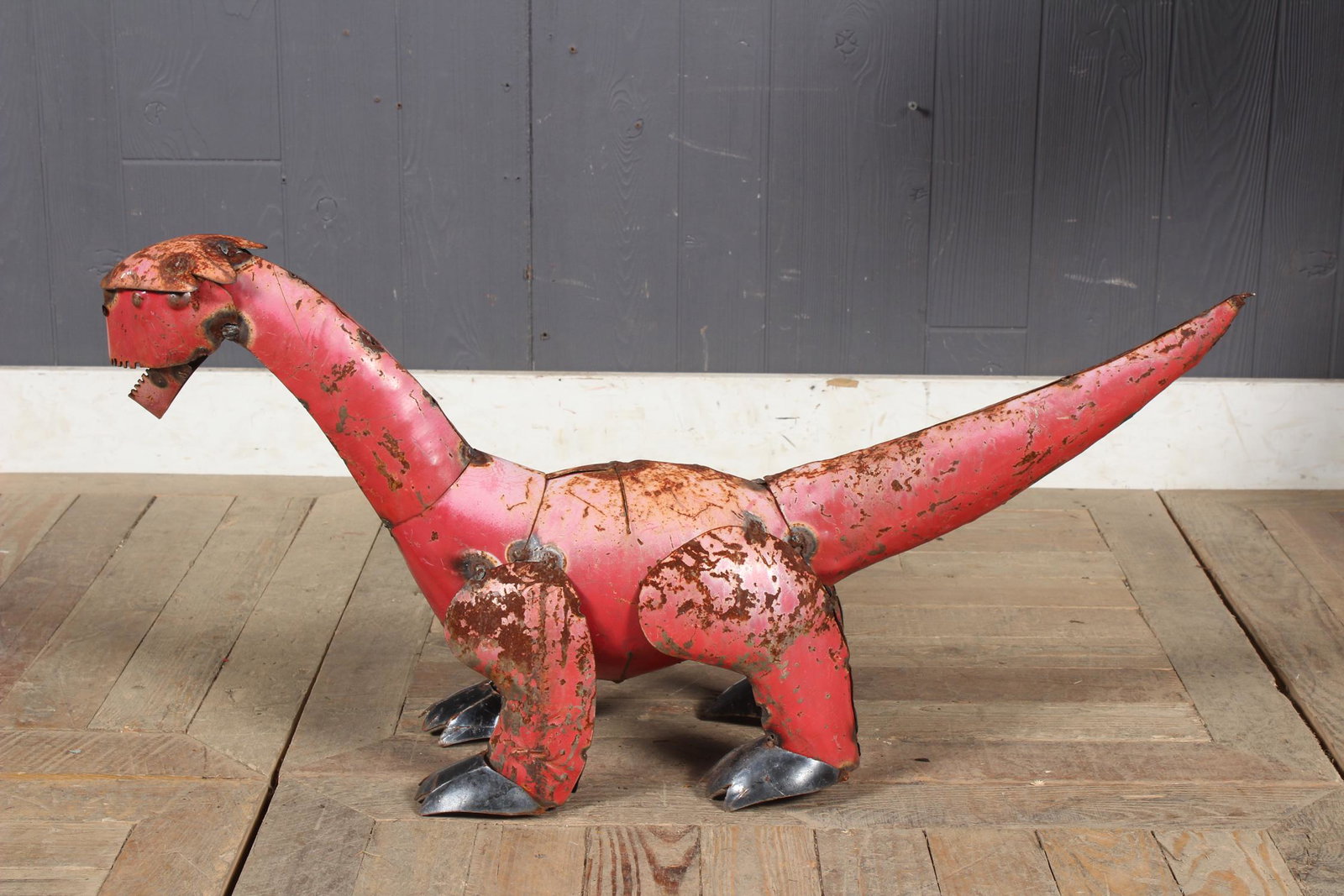 Folk Art Steel T-Rex Dinosaur Sculpture: A charming folk art painted metal dinosaur garden sculpture. Size: 15" H x 7" W x 31" D
