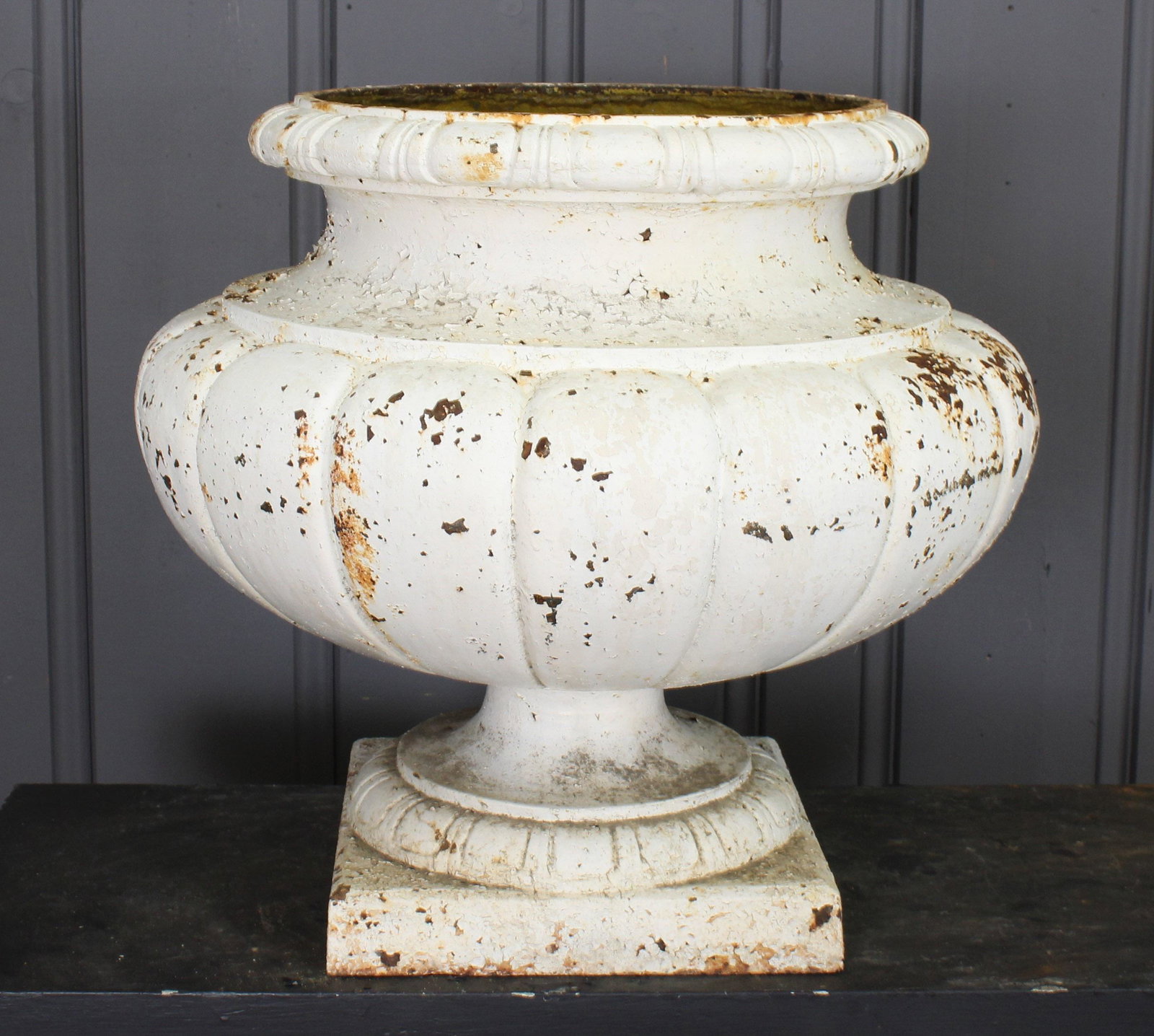 Cast Iron Urn Melon: A very good late 19th century French cast iron garden urn with egg and dart rim over melon form bowl and stepped base. 21"H x 24"W