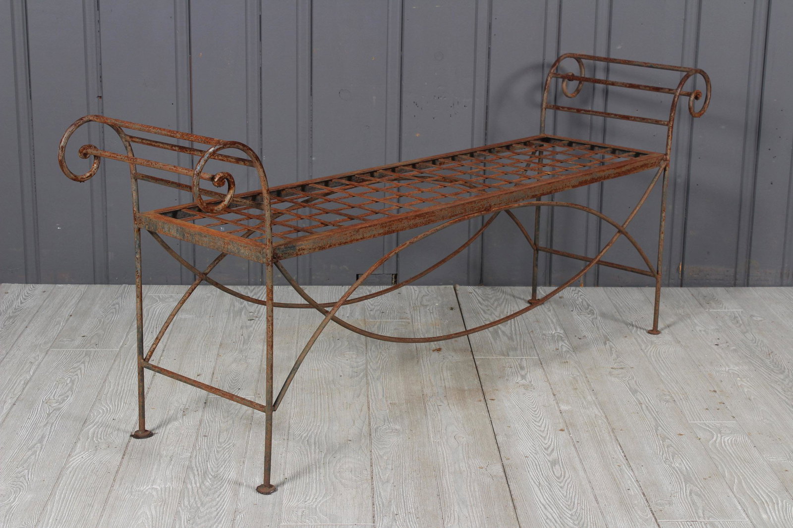 Regency Style Wrought Iron Bench: A regency style wrought iron garden bench with scrolling arms. 25 1/2" x 63 1/2" x 15"