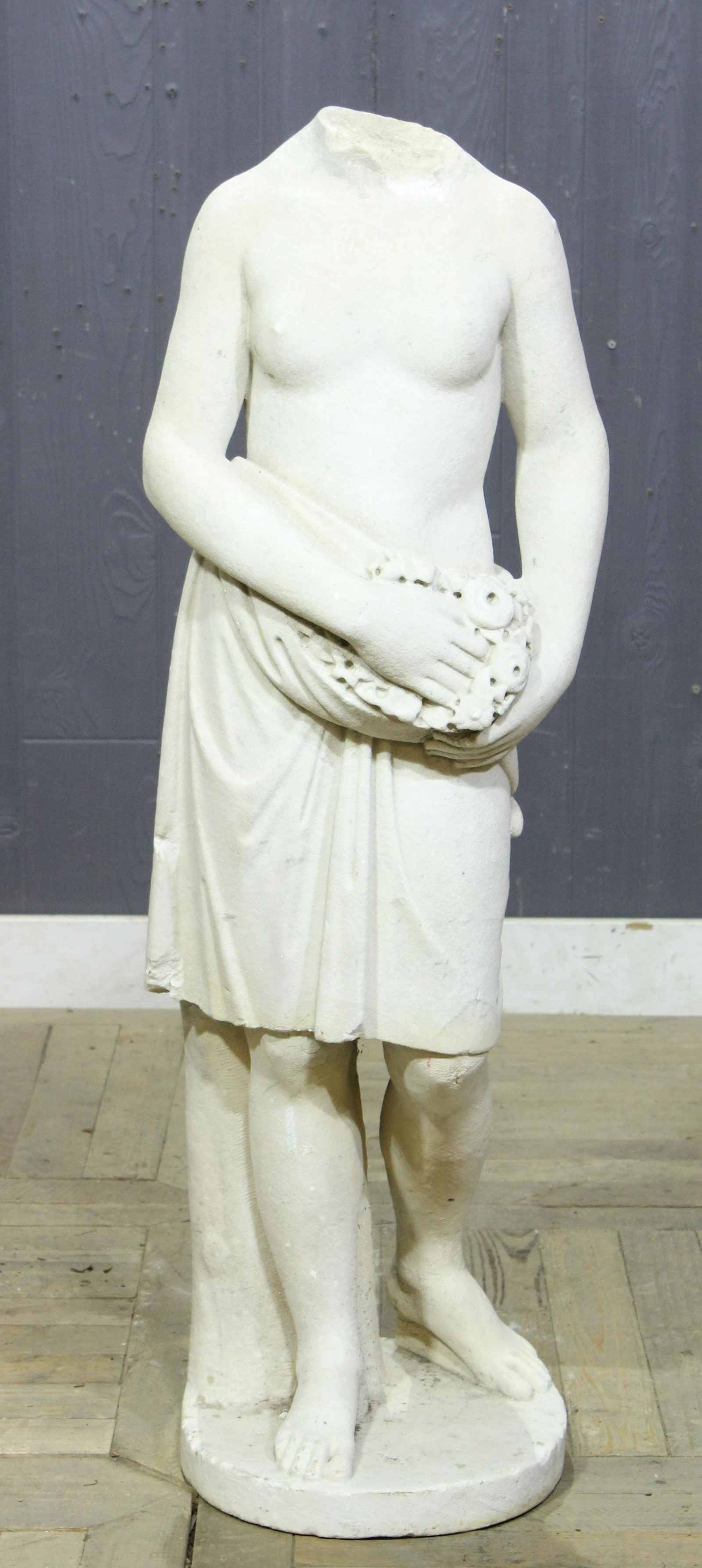 19th C Italian Carved Marble Figure: A late 19th century Italian carved marble neoclassical figure with draped tunic and floral bouquet. Size: 43"H x 14"W x 12"D
