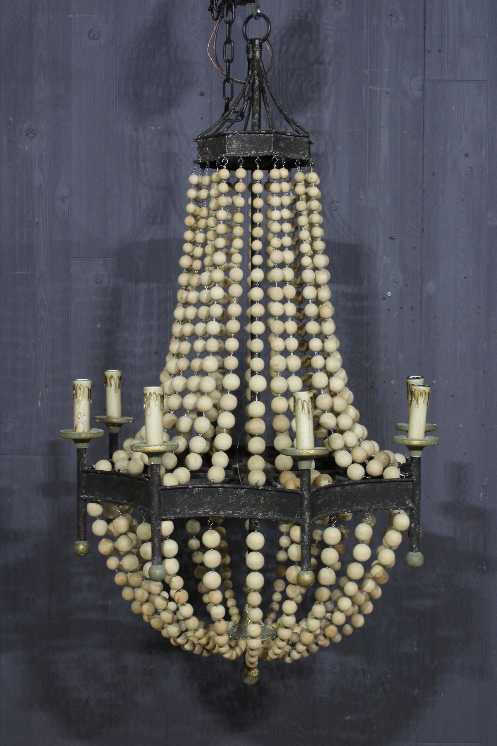 Wood and Iron Ring Chandelier: A wrought iron and graduated wood ball decorated chandelier having gilt decorated details. Size: 46"H x 27"W x 27"D