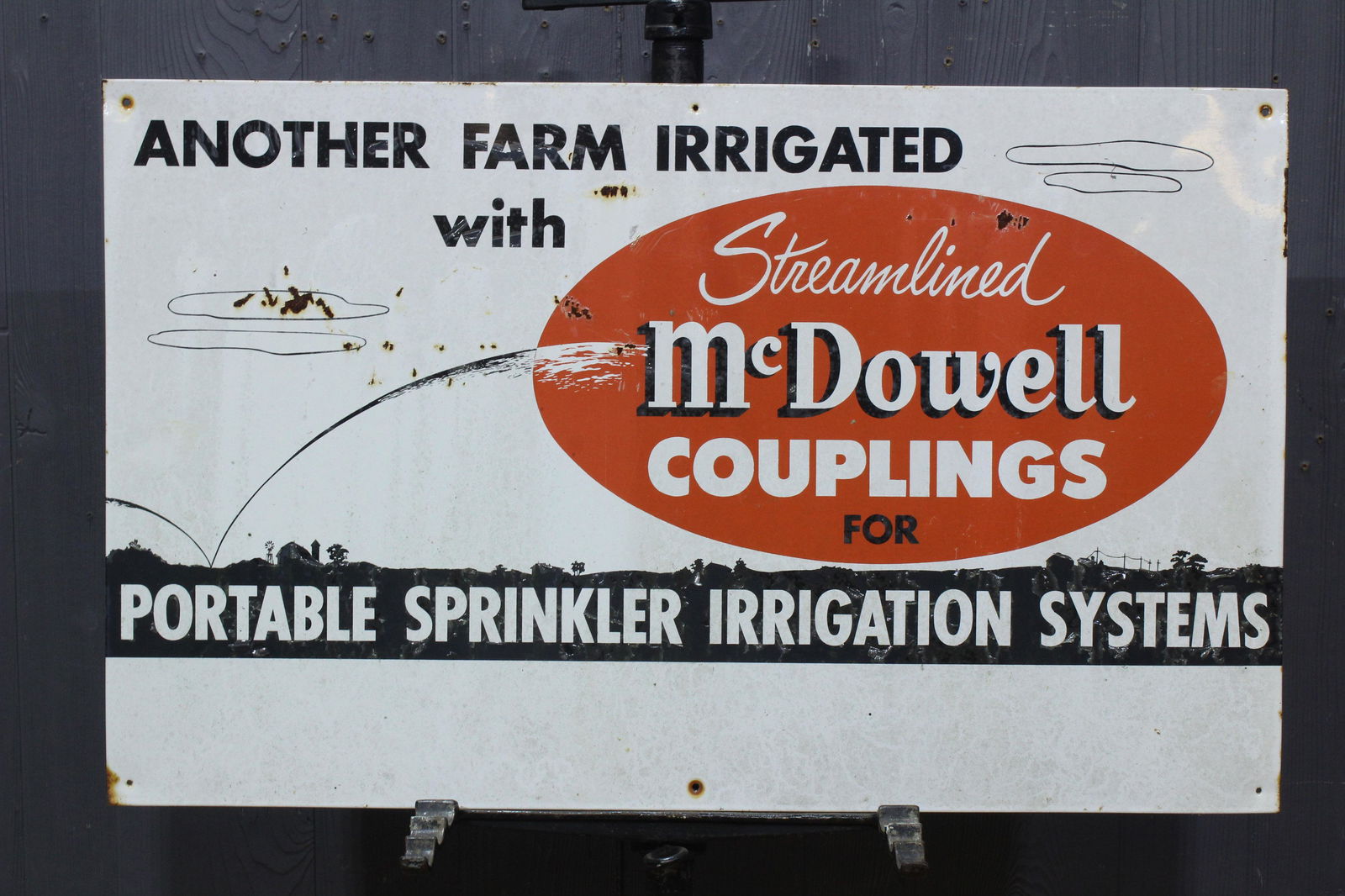 McDowell Couplings Porcelain over Iron Sign: Streamlined McDowell Couplings Porcelain over Iron Sign, "Another Farm Irrigated with Streamlined McDowell Couplings for Portable Sprinkler Irrigation Systems". Size: 18" H x 29.25" W.