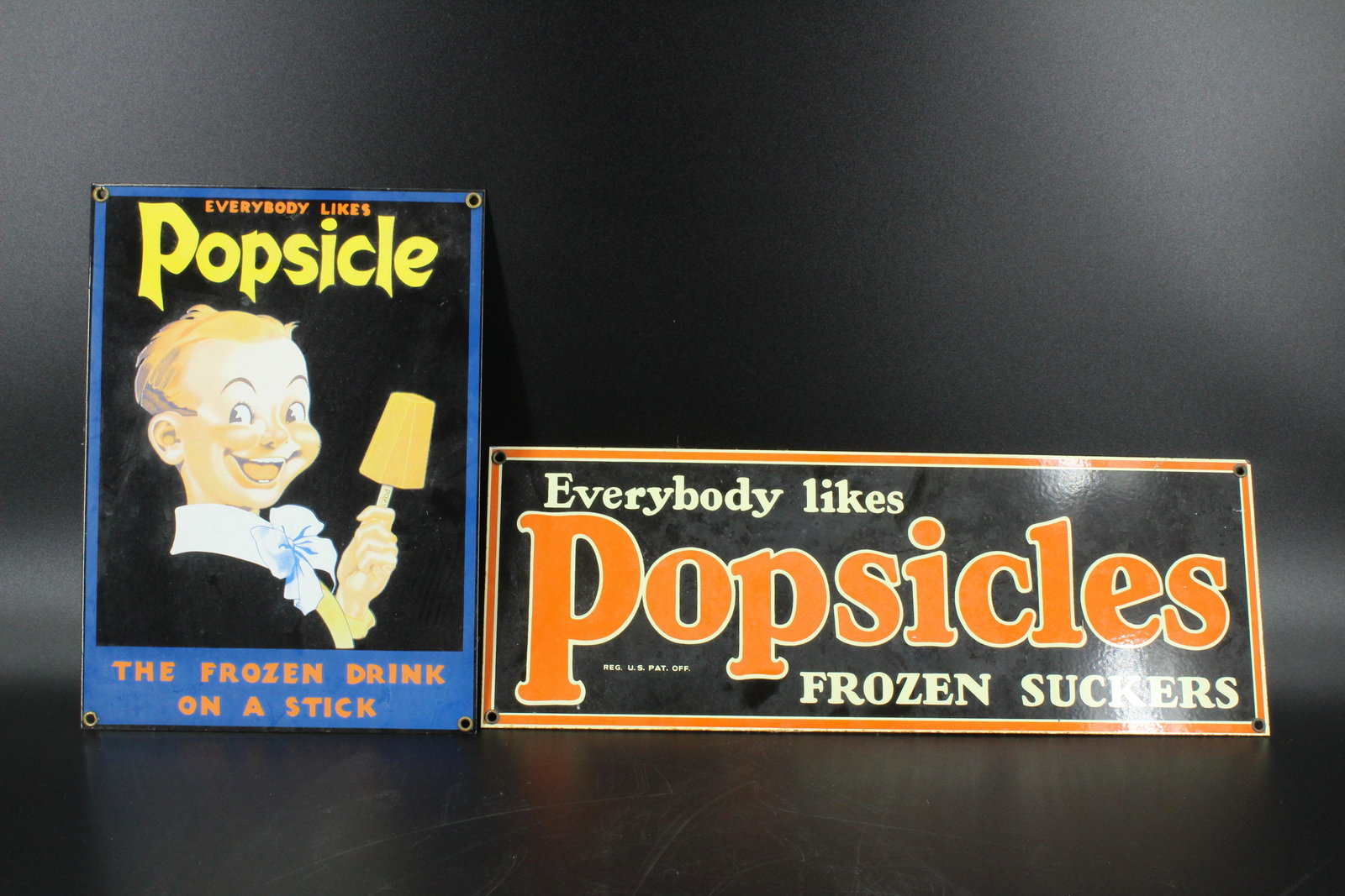 2 Everybody Likes Popsicles Porcelain Adv Signs: 2 Everybody Likes Popsicles Porcelain Advertising Signs, porcelain over iron, includes Everybody Likes Popsicles Frozen Suckers sign, 6.5" H x 18" W, and Everybody Likes Popsicle The Frozen Drink on a