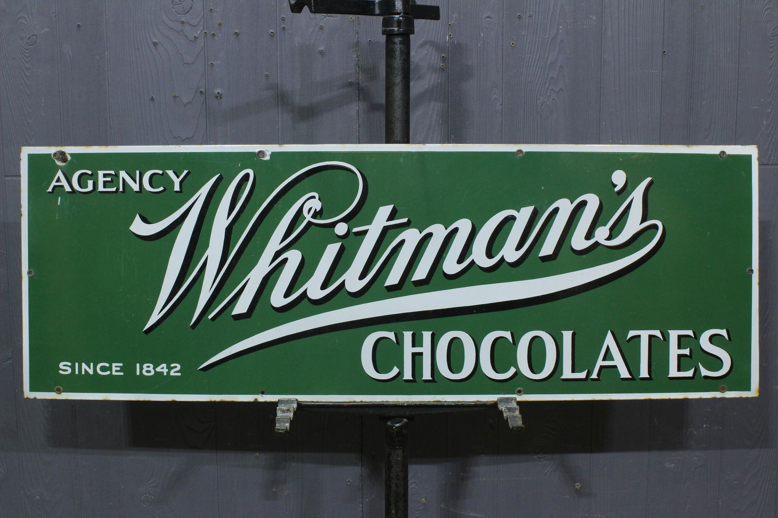 Whitman's Chocolates Porcelain Advertising Sign: Whitman's Chocolates Porcelain Advertising Sign, porcelain on iron, "Agency Whitman's Chocolates, Since 1842", has been painted on the back side. Size: 13.5" H x 39.5" W.