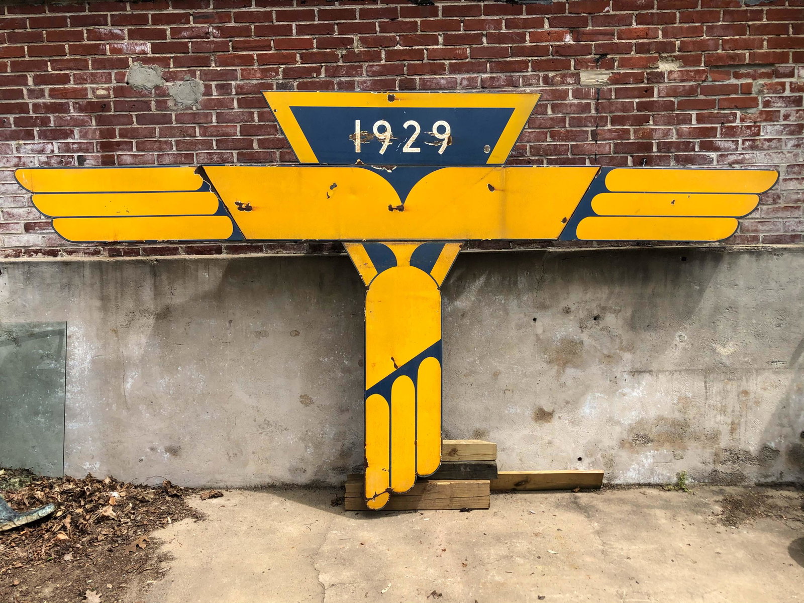 Golden Age of Aviation Hangar Sign: A rare Kellet Autogrio Corporation enameled metal trade sign showing the three wing design and marked with the founding date of 1929. The signs original brilliant blue and yellow colors create a drama