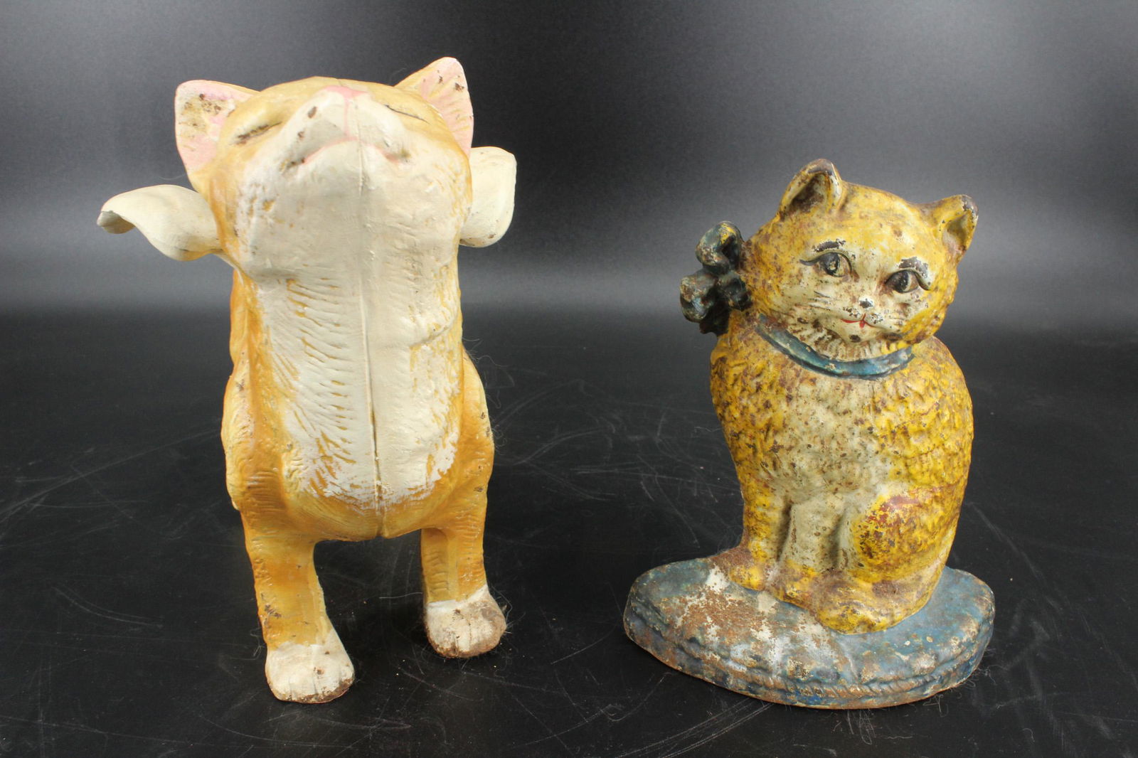 2 Painted Cast Iron Cat Door Stops: 2 Painted Cast Iron Cat Door Stops, includes a seated cat door stop, impressed numbers on back, and a standing cat with wings. Size: 9"H x 12"W x 6.5"D