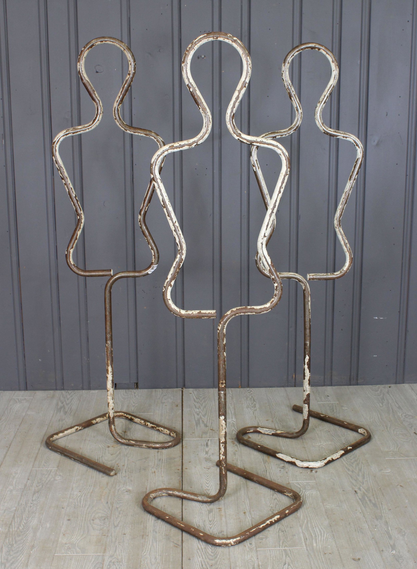 3 MCM French Figural Clothing Displays: A group of three French mid century modern iron figural clothing displays. Each having silhouette form and remnants of paint. 65" x 17 1/2" x 18"