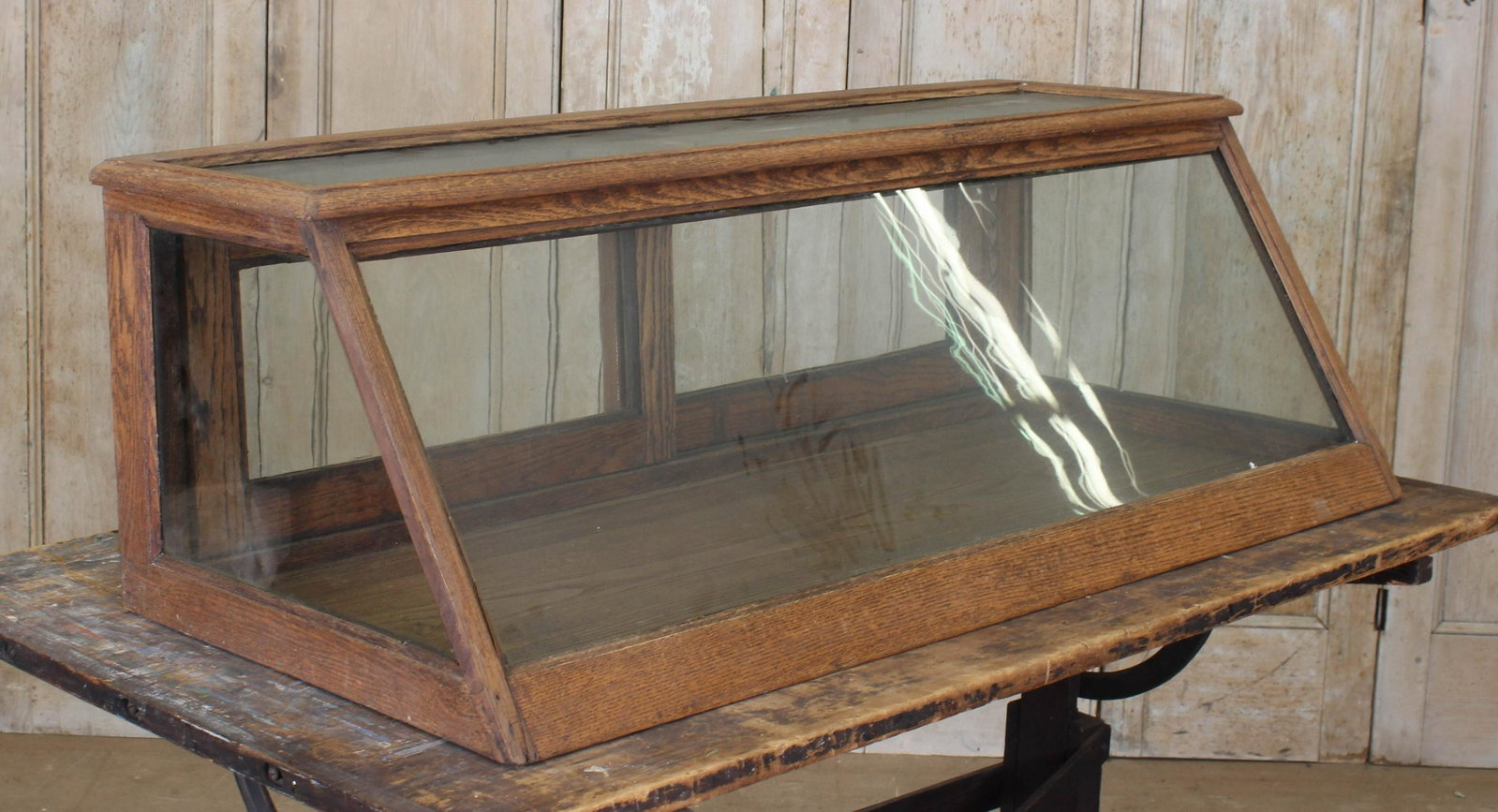 Oak General Store Counter Top Display Cabinet: Oak Counter Top Display Cabinet, double sliding doors, angled front. Size: 16" x 46" x 22"